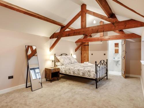 a bedroom with a bed and wooden beams at 4 Bed in Dunstable oc-93632 in Totternhoe
