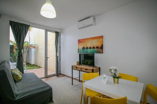 a living room with a couch and a table at Pé na Areia - Guest House in Vila Real de Santo António