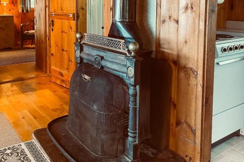 an old woodburning stove in a living room at Bay-View Getaway w/ Deck Between Camden & Belfast! in Northport
