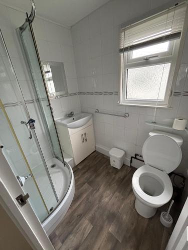 a bathroom with a toilet and a shower and a sink at 192, Two bed newly refurbished chalet on Sund0wner Holiday Park - Sleeps 5, pet friendly - Includes electricity, bed linen and towels - Entertainment options close by in Hemsby