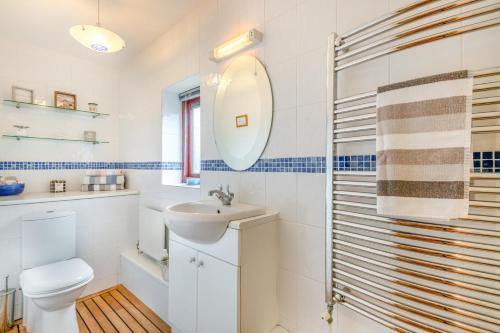 a bathroom with a toilet sink and a mirror at 2 Bed in Barnby oc-t28265 in North Cove