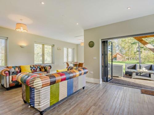 a living room with a couch and a sliding glass door at 2 Bed in Kings Lynn oc-96048 in Middleton