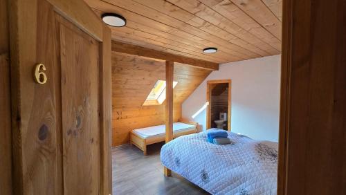 a bedroom with a bed and a wooden ceiling at Chata pod Červenou studňou in Banská Štiavnica