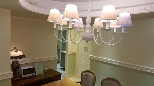 a chandelier in a dining room with a table at 橙舍太空艙 TW Capsule Hostel in Taipei