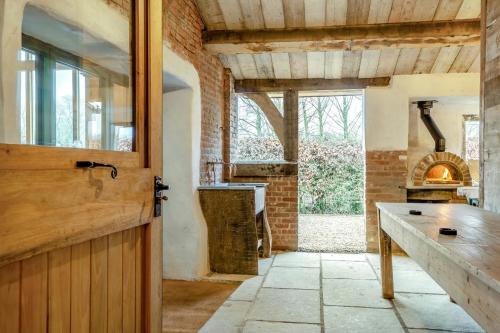 a kitchen with a wooden door and a stove at 5 Bed in Kings Lynn oc-96250 in Clenchwarton
