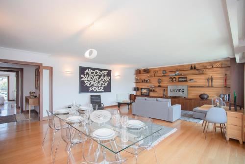a living room with a glass table and a couch at Liiiving in Porto - Douro Riverside Apartment in Porto