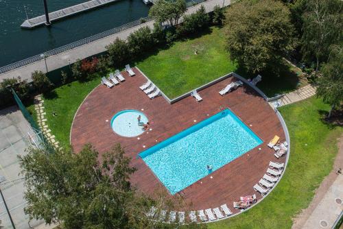 an overhead view of a large swimming pool with lounge chairs at Liiiving in Porto - Douro Riverside Apartment in Porto