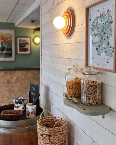 a wall with a shelf with jars of granola at Aux Genêts D'Or in Trévé