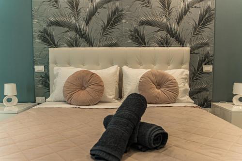 a bed with two pillows and a blanket on it at Palazzo Margò - Private Luxury Palace with Sea View in Mola di Bari