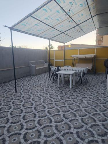 a patio with tables and chairs under a canopy at Bella Reggio in Reggio di Calabria
