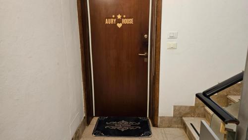 a brown door with a sign on it in a hallway at AURY HOUSE -HistoricCenter- in Cremona
