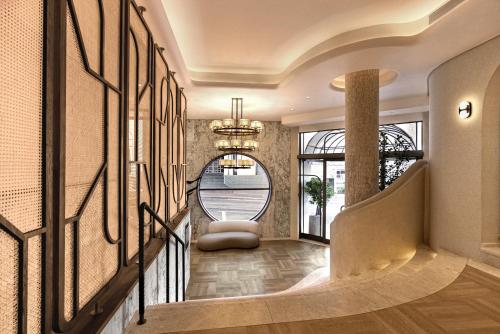 a hallway with a staircase with a chandelier at The Cole Boutique Hotel & Spa in Cape Town