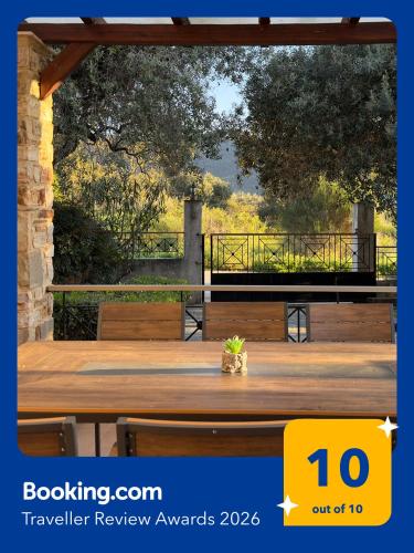 a wooden deck with a table with a view at Villa Bellissimo in Skala Potamias