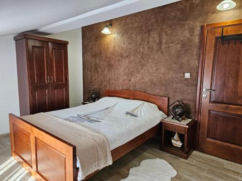 a bedroom with a large bed and a wooden cabinet at Apartments Nadja in Kotor