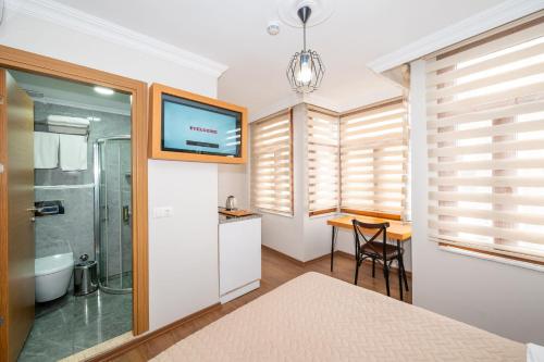 a bathroom with a shower and a sink at Aras Life Hotel in Istanbul