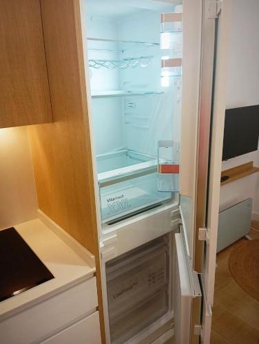 an empty refrigerator with its door open in a kitchen at Alameda Lofts Pontevedra in Pontevedra