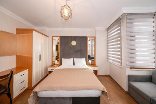 a bedroom with a bed and a couch at Aras Life Hotel in Istanbul
