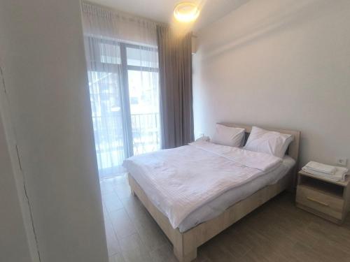 a bedroom with a bed and a large window at Apartment in Verin Apart hotel in Dilijan in Dilijan