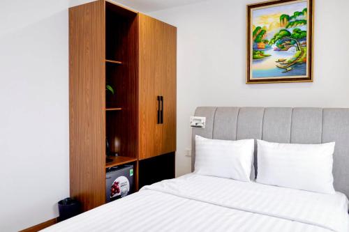 a bedroom with a bed and a cabinet at KHEM BEACH Hotel in Phú Quốc