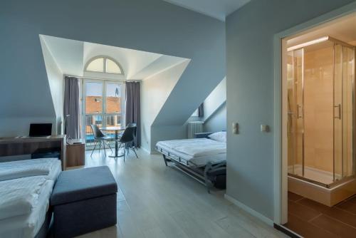En eller flere senge i et værelse på Hotel Astor