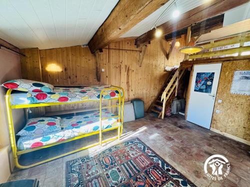 a bedroom with a bunk bed and a staircase at La maison in Davejean