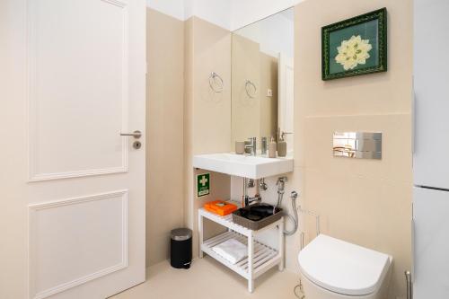 a bathroom with a white toilet and a sink at Modern Lisbon Apartments by Soulplaces in Lisbon