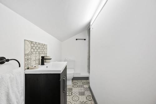 a white bathroom with a sink and a shower at The Reading Hub in Reading