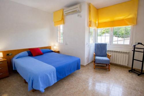 a bedroom with a blue bed and a blue chair at Nature & Tranquility only 25km from Barcelona in Torrelles de Llobregat