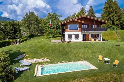 a house with a swimming pool in front of a house at Villa Tirolese in Due Cossani