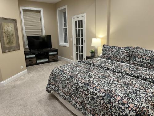 a bedroom with a bed and a flat screen tv at The Wrigleyville VIP-200 Steps from Wrigley Field in Chicago