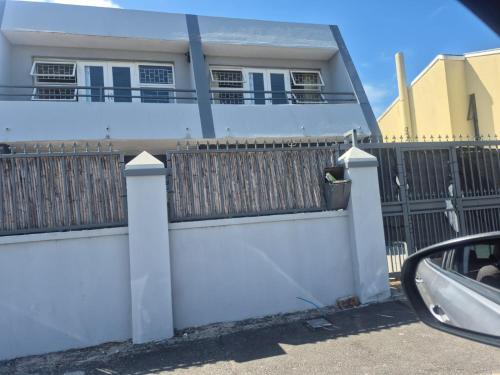 a white fence in front of a house at Maglovir Plumstead 5 rooms bulk in Plumstead