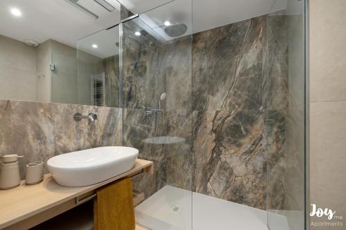 a bathroom with a sink and a shower at Apartamenty Łukęcin Joy me 3 in Łukęcin