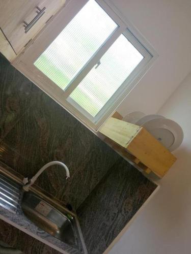 a window above a sink in a kitchen at Serenity villa in Weligama