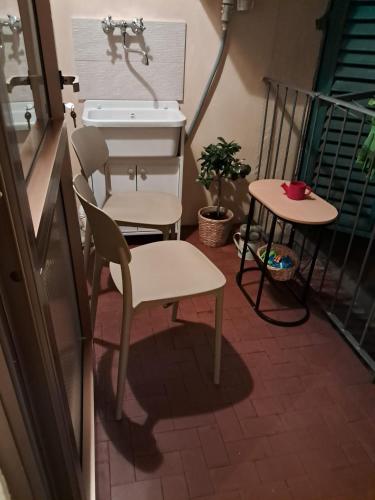 a balcony with a sink and a chair and a table at Casa Larissa in Rufina
