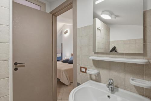 a bathroom with a sink and a mirror at Case Vacanze Celeste in Marzamemi