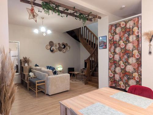 a living room with a couch and a staircase at L'Atelier des Rêves in Saverne