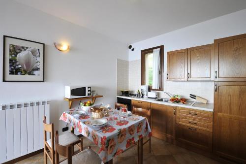 a kitchen with a table with a table cloth at Borgo La Sorgente - Erica in Gravedona