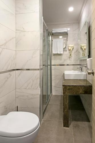 a bathroom with a toilet and a sink at Glamour Resort & SPA in Side