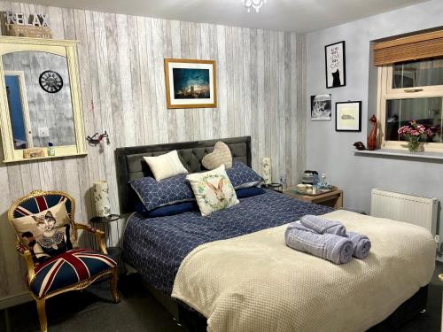 a bedroom with a bed and a chair at The Purrfect Creative Retreat in Gainsborough