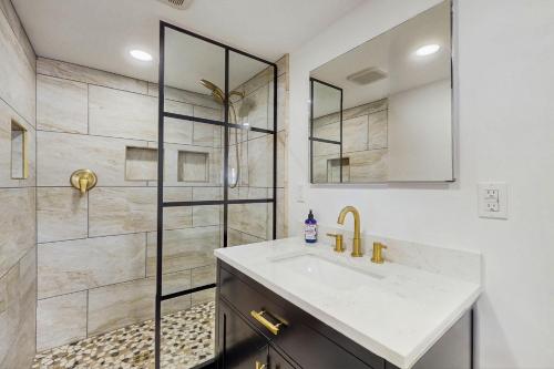 a bathroom with a sink and a shower at 12 Mi to Lake George! Quiet Adirondack Escape in Fort Ann