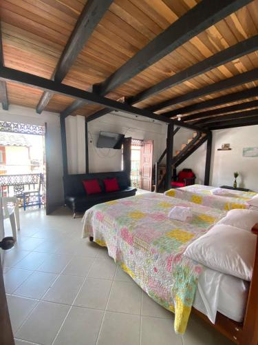 a bedroom with a large bed and a couch at Europa Ecotours in Jardin