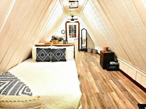 a bedroom with a bed in a attic at Forget Me Not Aframe-Cave Run in Wellington