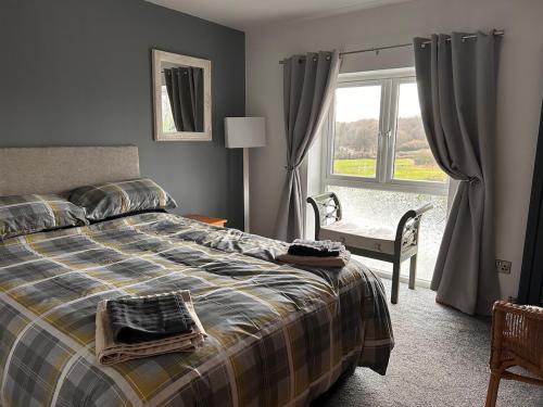 a bedroom with a bed and a chair and a window at Forest view in Staunton