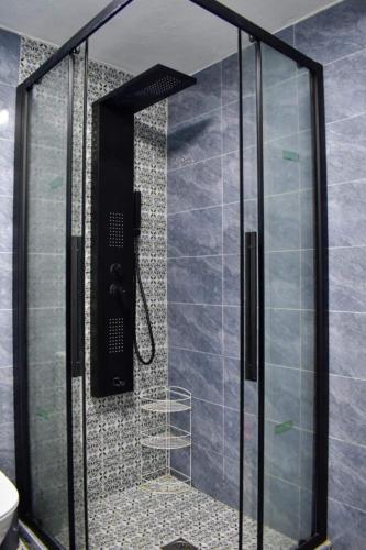 a shower with a glass door in a bathroom at Stella's House in Skopelos Town