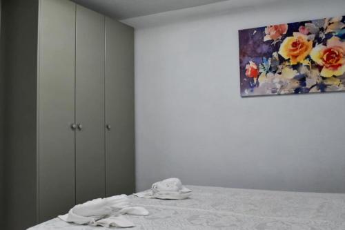 a white table with a painting on the wall at Stella's House in Skopelos Town