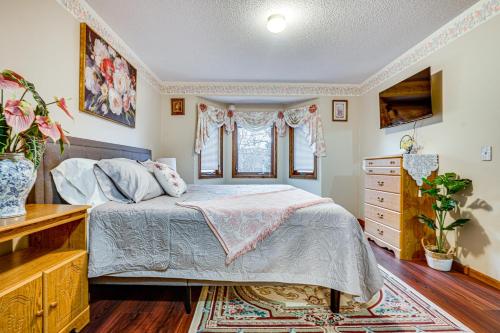 a bedroom with a bed and a dresser and a window at Deck & Outdoor Dining! Spacious St Paul Getaway in North Saint Paul