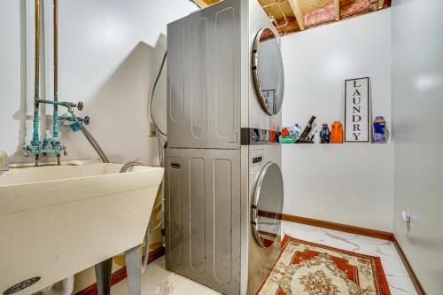 a small refrigerator in a bathroom next to a sink at Deck & Outdoor Dining! Spacious St Paul Getaway in North Saint Paul