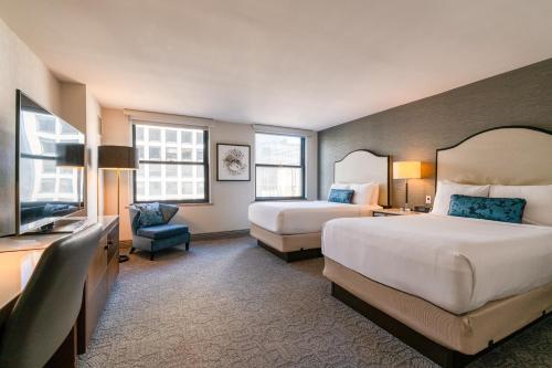 a hotel room with two beds and a television at InterContinental Chicago Magnificent Mile by IHG in Chicago
