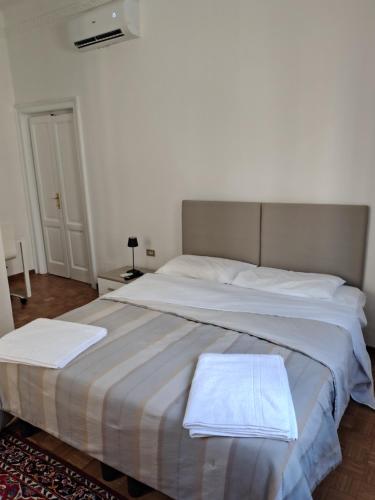 a bedroom with a large bed with two towels on it at Lacasabianca guest house saronno in Saronno