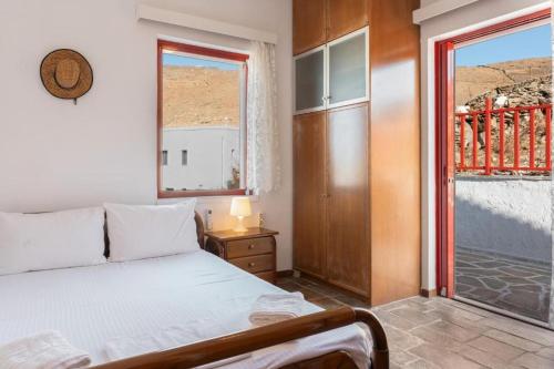 a bedroom with a bed and a large window at Villa Christina 2 in Mérikhas